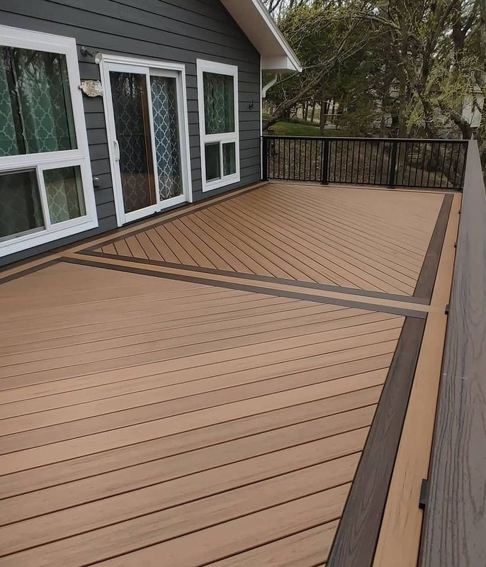 Deck railing at sunset over water
