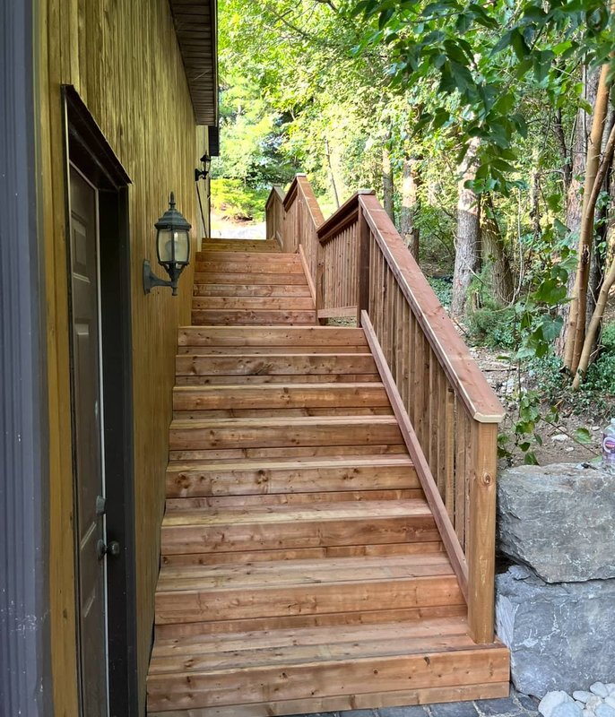 Wooden deck stairs along house exterior