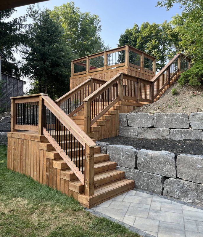 Cedar deck stairs with stone retaining wall