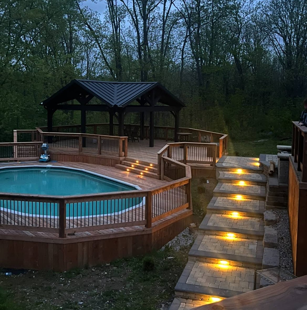 Pool deck with gazebo at dusk